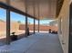 Covered back porch with concrete floor offering shade and a view of the spacious backyard at 31 White Burch Ln, Pahrump, NV 89048