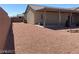 Expansive gravel backyard surrounded by brick wall offering blank canvas for landscaping dreams at 31 White Burch Ln, Pahrump, NV 89048