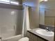 Bright bathroom featuring a shower-tub combination with white tile and a single sink vanity at 31 White Burch Ln, Pahrump, NV 89048