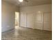 Bedroom with wood-look flooring and view into ensuite bath and large closet with sliding doors at 31 White Burch Ln, Pahrump, NV 89048