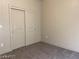 Cozy bedroom featuring neutral walls, plush carpeting, and sliding-door closet at 31 White Burch Ln, Pahrump, NV 89048