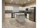 Modern kitchen with stainless steel appliances, white cabinets, gray countertop, and a center island at 31 White Burch Ln, Pahrump, NV 89048