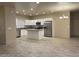 Open-concept kitchen featuring white cabinetry, stainless steel appliances, and a functional center island at 31 White Burch Ln, Pahrump, NV 89048