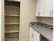 Pantry and kitchen with white cabinets and a gray countertop at 31 White Burch Ln, Pahrump, NV 89048