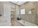 Modern bathroom with glass shower, linen closet, neutral tile and dual sink at 3218 Squire St, Las Vegas, NV 89135