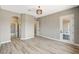 Spacious bedroom with wood floors, decorative lighting, and an ensuite bathroom at 3218 Squire St, Las Vegas, NV 89135