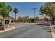 Elegant gated entrance to the community with mature trees and landscaping, ensuring privacy at 3218 Squire St, Las Vegas, NV 89135