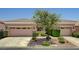 Charming single-story home featuring a two-car garage and a lush, landscaped front yard at 3218 Squire St, Las Vegas, NV 89135