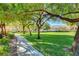 Picturesque community green space with walking path and shade trees, enhancing the neighborhood's appeal at 3218 Squire St, Las Vegas, NV 89135