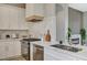 Modern kitchen features marble countertops, stainless steel appliances, and sleek white cabinetry at 3218 Squire St, Las Vegas, NV 89135