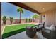 Inviting covered patio with modern outdoor furniture and a well-manicured yard, perfect for relaxation at 3218 Squire St, Las Vegas, NV 89135