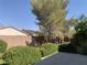 View of the landscaped backyard with mature trees and shrubs at 3328 White Bark Pine St, Las Vegas, NV 89129