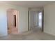 Spacious bedroom featuring neutral carpet, arched doorways, and bright, airy ambiance at 3328 White Bark Pine St, Las Vegas, NV 89129