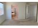 Well-lit bedroom showcasing neutral carpet, arched doorways, and entry to a bathroom at 3328 White Bark Pine St, Las Vegas, NV 89129