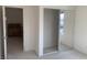 Carpeted bedroom featuring mirrored sliding closet doors and view to the office at 3328 White Bark Pine St, Las Vegas, NV 89129
