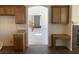 View of entry and stairway from kitchen featuring light wood cabinets and tile flooring at 3328 White Bark Pine St, Las Vegas, NV 89129