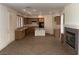Open-concept kitchen featuring light wood cabinets, tile flooring, and fireplace at 3328 White Bark Pine St, Las Vegas, NV 89129