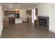 Open-concept kitchen featuring light wood cabinets, tile flooring, and fireplace at 3328 White Bark Pine St, Las Vegas, NV 89129