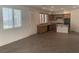 Open-concept kitchen featuring light wood cabinets, tile flooring, and black appliances at 3328 White Bark Pine St, Las Vegas, NV 89129