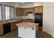 Open-concept kitchen featuring light wood cabinets, tile flooring, and island at 3328 White Bark Pine St, Las Vegas, NV 89129