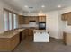 Open-concept kitchen featuring light wood cabinets, tile flooring, and island at 3328 White Bark Pine St, Las Vegas, NV 89129