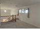 Open floor plan living room featuring neutral walls, plush carpeting, and bright, sunny windows at 3328 White Bark Pine St, Las Vegas, NV 89129
