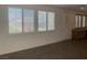 Bright living room featuring large windows with shutters and beautiful tiled flooring at 3328 White Bark Pine St, Las Vegas, NV 89129