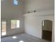 Open floor plan living room with an arched doorway and exterior access at 3328 White Bark Pine St, Las Vegas, NV 89129