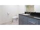 Bathroom with a black granite countertop, neutral walls, and tile floors at 3380 Kensbrook St, Las Vegas, NV 89121
