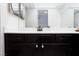Updated bathroom with a black vanity, marble countertops, and modern fixtures at 3380 Kensbrook St, Las Vegas, NV 89121
