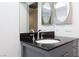 Bathroom featuring a dark granite countertop and round mirrors at 3380 Kensbrook St, Las Vegas, NV 89121