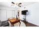 Bedroom with wood flooring, ceiling fan, and a desk at 3380 Kensbrook St, Las Vegas, NV 89121