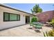 Private courtyard with a dining set surrounded by lush landscaping at 3380 Kensbrook St, Las Vegas, NV 89121