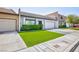 Charming home features a two-car garage, manicured lawn, and lovely front entrance at 3380 Kensbrook St, Las Vegas, NV 89121