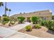Low-rise building with manicured landscaping, shrubbery and sidewalks on a sunny day at 3380 Kensbrook St, Las Vegas, NV 89121
