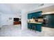 Open kitchen with breakfast bar and modern appliances, seamlessly connected to living space at 3380 Kensbrook St, Las Vegas, NV 89121