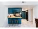 Open kitchen with breakfast bar and modern appliances, seamlessly connected to living space at 3380 Kensbrook St, Las Vegas, NV 89121