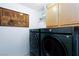 Laundry room with side-by-side washer and dryer, storage and decor at 3380 Kensbrook St, Las Vegas, NV 89121