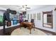 Cozy office with ceiling fan, wood flooring, and a collection of wall art at 3380 Kensbrook St, Las Vegas, NV 89121