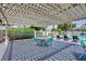 Community pool with a shaded pergola area, tables, chairs, and lounge seating at 3380 Kensbrook St, Las Vegas, NV 89121