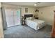 Cozy bedroom with carpet flooring, a comfortable bed, and sliding door access to the outdoors at 3585 Winner Dr, Las Vegas, NV 89120