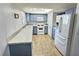 Well-lit kitchen with white appliances, blue cabinets, and quartz countertops at 3585 Winner Dr, Las Vegas, NV 89120
