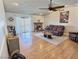 Cozy living room features a brick fireplace, hardwood floors, and sliding doors to the backyard at 3585 Winner Dr, Las Vegas, NV 89120