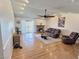 Cozy living room features a brick fireplace, hardwood floors, and sliding doors to the backyard at 3585 Winner Dr, Las Vegas, NV 89120