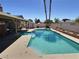 A sparkling in-ground pool and attached spa are featured in this outdoor backyard retreat on a sunny day at 3585 Winner Dr, Las Vegas, NV 89120