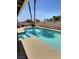 The backyard features a shimmering pool, spa, and well-manicured desert landscaping at 3585 Winner Dr, Las Vegas, NV 89120