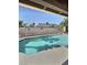 A serene swimming pool shimmers under a clear sky, framed by a covered patio and desert landscape at 3585 Winner Dr, Las Vegas, NV 89120