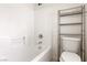 Bathroom with shower and tub combination and metal shelving unit at 3828 Prairie Orchid Ave, North Las Vegas, NV 89081