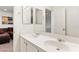 Bathroom featuring double sinks and mirrors at 3828 Prairie Orchid Ave, North Las Vegas, NV 89081