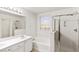 Bright bathroom features a soaking tub, glass enclosed shower, and double sink vanity at 3828 Prairie Orchid Ave, North Las Vegas, NV 89081